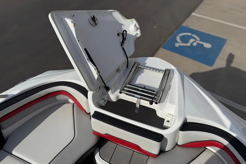 Slide: The Image of 2019 Yamaha Boats 242X E-Series with open storage compartment and ladder. - 77