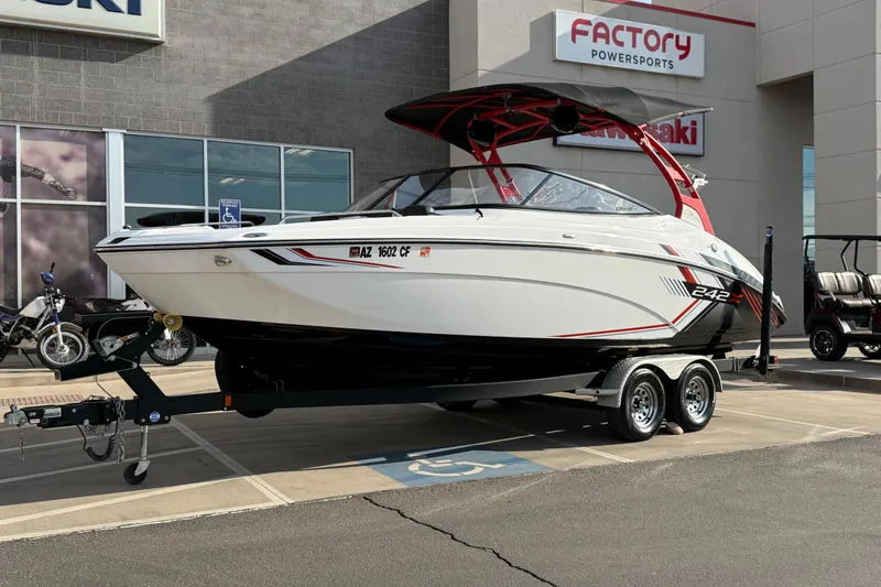 Slide: The Image of 2019 Yamaha Boats 242X E-Series on trailer at dealership, Factory Powersports. - 8