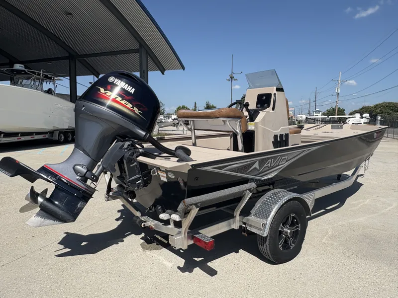 Slide: The Image of 2023 Avid 18 Rogue CC boat console with steering wheel and control panel. - 2