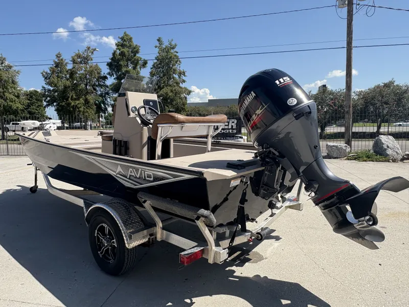 Slide: The Image of 2023 Avid 18 Rogue CC boat on trailer, parked outdoors under clear sky. - 4