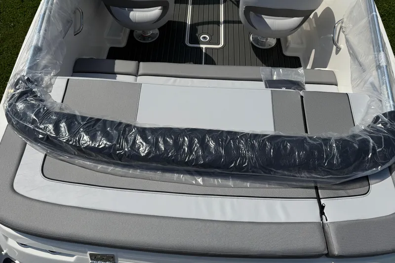 Slide: The Image of 2025 Bayliner VR4 Bowrider I/O boat interior with cushioned seating and protective plastic cover. - 5