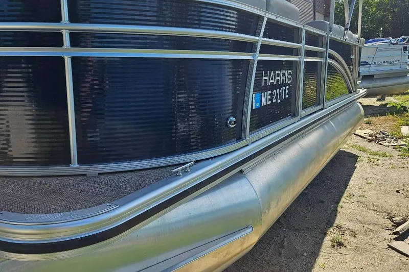 Slide: The Image of 2018 Harris Cruiser 200 pontoon boat, side view with registration number ME 211TE. - 3