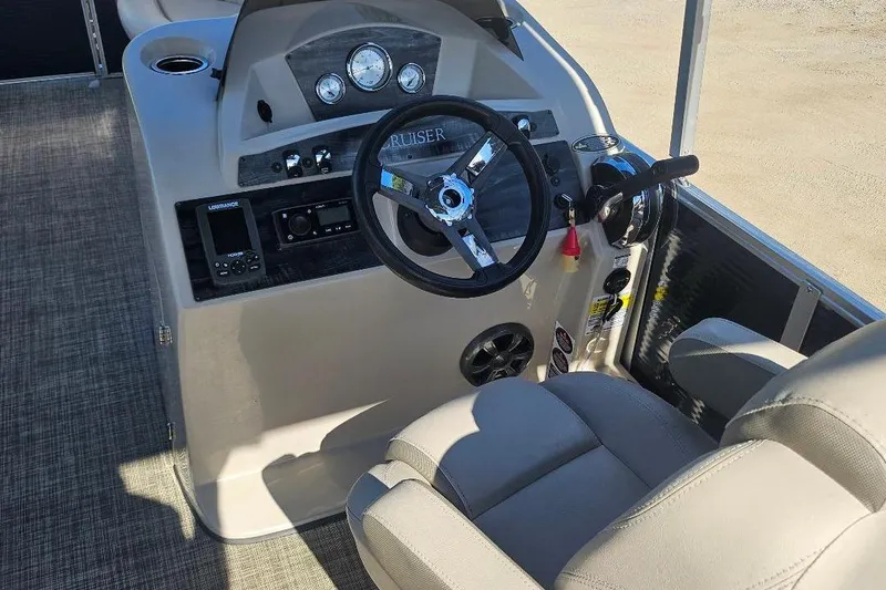 Slide: The Image of 2018 Harris Cruiser 200 boat dashboard with steering wheel and control panel. - 6
