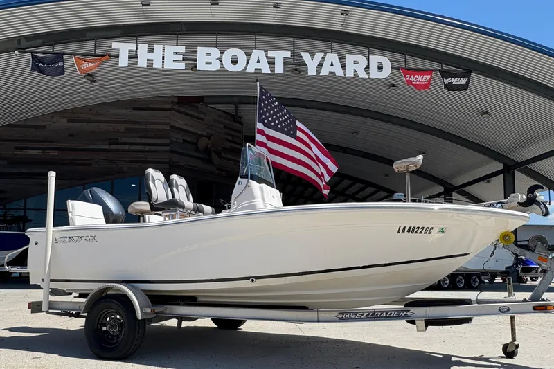 Slide: The Image of 2014 Seafox 180 Viper boat on trailer at The Boat Yard, American flag displayed. - 1