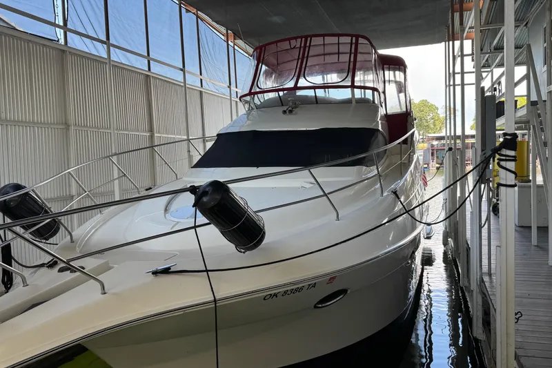 The Image of 2003 Silverton 410 Sport Bridge yacht docked in a covered marina. - 0