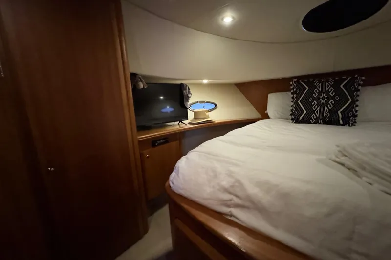 Slide: The Image of Luxurious cabin interior of 2003 Silverton 410 Sport Bridge with cozy bedding and ambient lighting. - 11