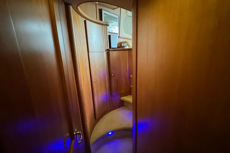 Slide: The Image of Interior of 2003 Silverton 410 Sport Bridge with wooden paneling and blue accent lighting. - 14