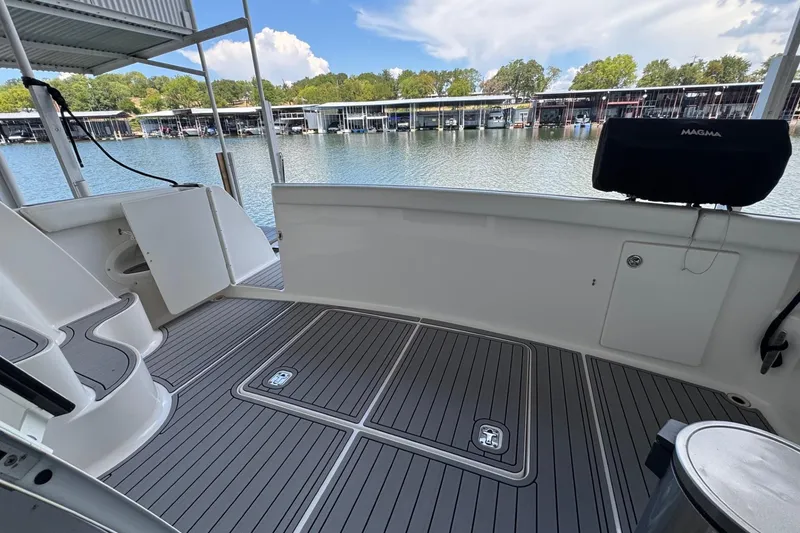 Slide: The Image of 2003 Silverton 410 Sport Bridge boat deck with marina view, featuring sleek design and spacious layout. - 17