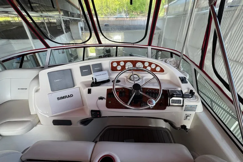 Slide: The Image of 2003 Silverton 410 Sport Bridge helm with Simrad navigation system and gauges. - 18