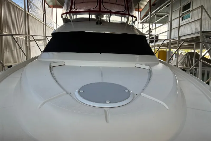 Slide: The Image of 2003 Silverton 410 Sport Bridge yacht docked in a covered marina. - 2