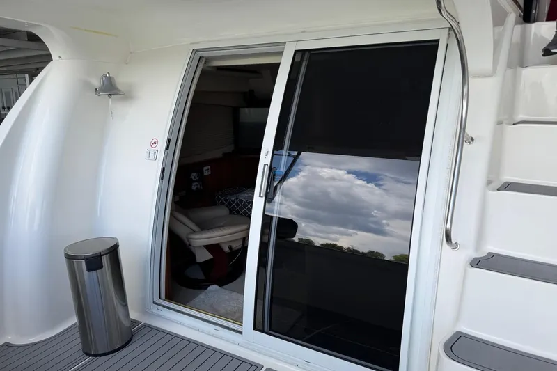 Slide: The Image of 2003 Silverton 410 Sport Bridge yacht with sliding glass door and modern interior. - 22