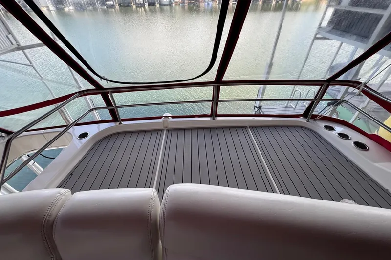 Slide: The Image of 2003 Silverton 410 Sport Bridge deck with water view, featuring sleek design and comfortable seating. - 25