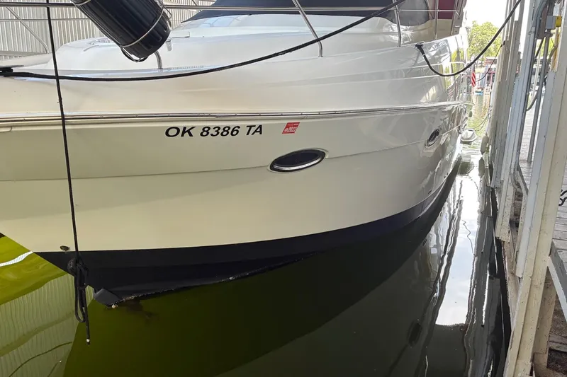 Slide: The Image of 2003 Silverton 410 Sport Bridge docked, displaying registration number OK 8386 TA. - 4