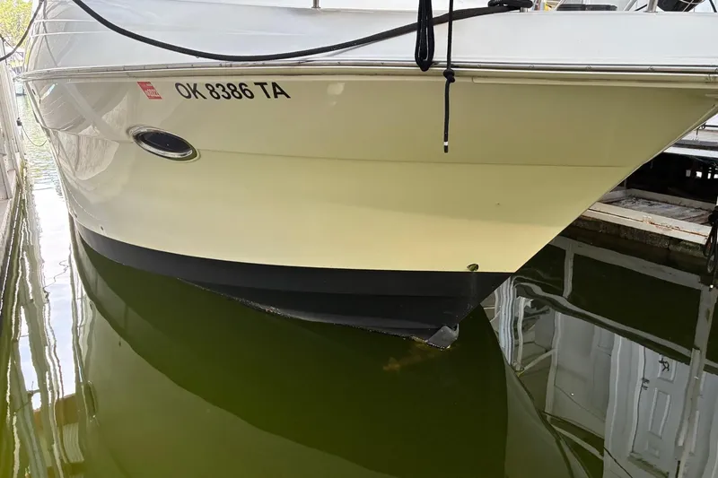 Slide: The Image of 2003 Silverton 410 Sport Bridge docked, showing hull and registration number OK 8386 TA. - 5