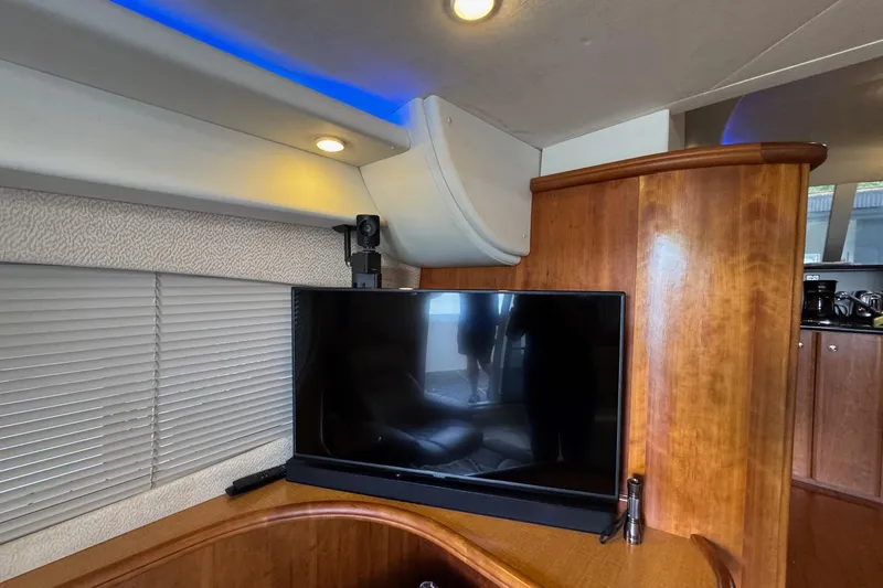 Slide: The Image of Interior of 2003 Silverton 410 Sport Bridge with TV and wooden cabinetry. - 7