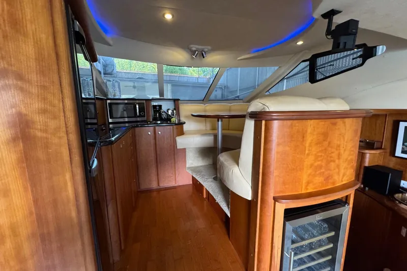 Slide: The Image of Interior of 2003 Silverton 410 Sport Bridge with wood cabinetry and seating area. - 8