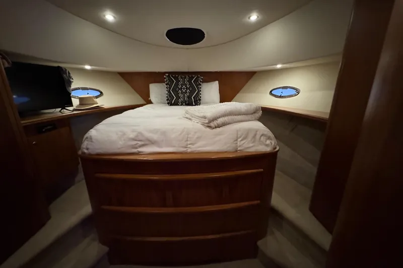 Slide: The Image of Luxurious cabin interior of 2003 Silverton 410 Sport Bridge yacht with cozy bedding. - 9