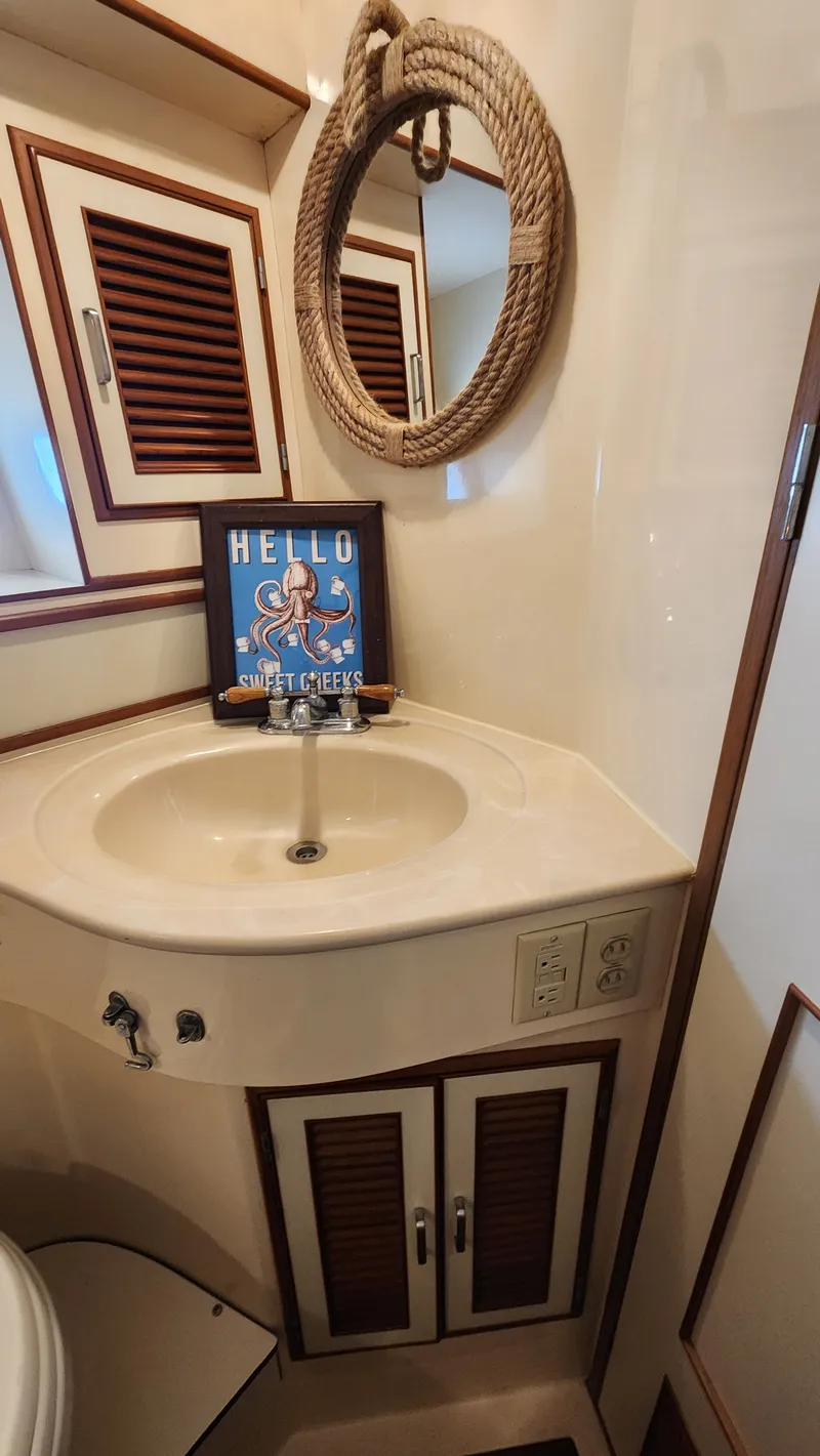 Slide: The Image of 1987 Hi-Star 48 Sundeck bathroom with nautical decor and rope mirror. - 17