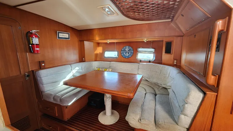 Slide: The Image of 1987 Hi-Star 48 Sundeck interior with cozy dining area and wooden finishes. - 20