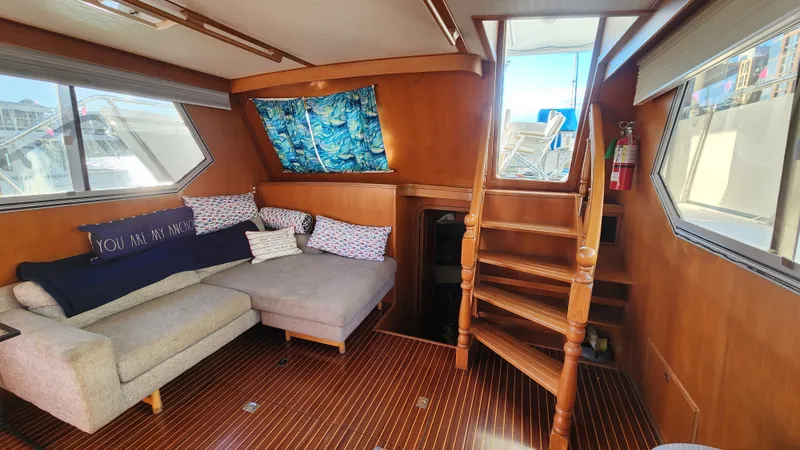 Slide: The Image of Interior of 1987 Hi-Star 48 Sundeck yacht with cozy seating and wooden stairs. - 37