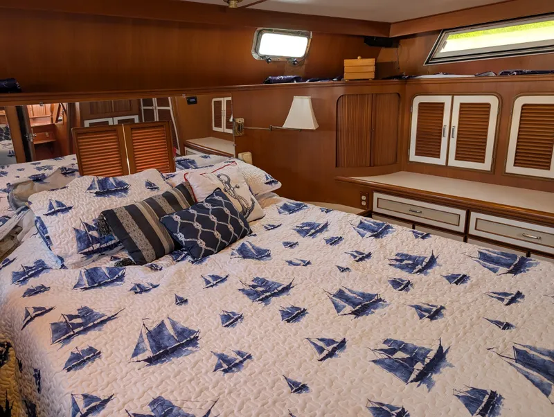 Slide: The Image of 1987 Hi-Star 48 Sundeck bedroom with nautical-themed bedding and wooden cabinetry. - 39
