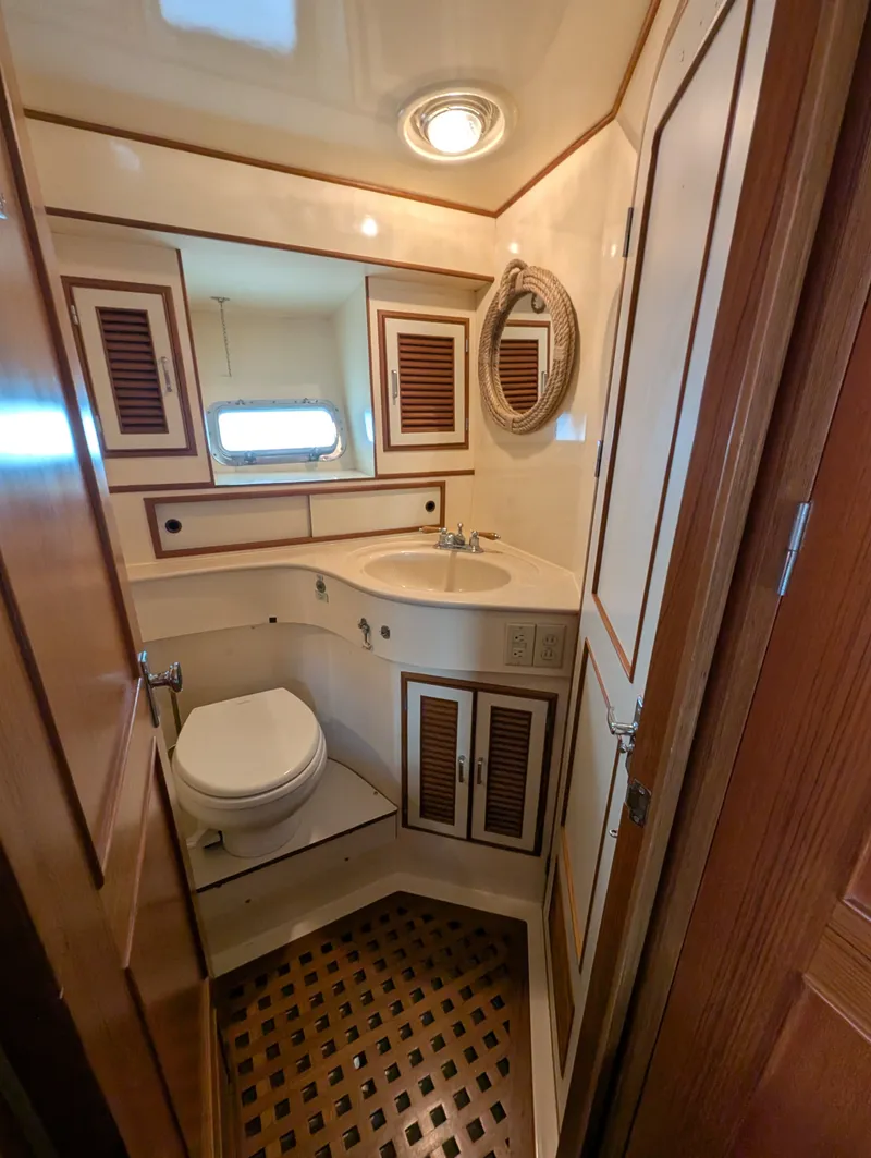 Slide: The Image of 1987 Hi-Star 48 Sundeck yacht bathroom with wooden accents and compact design. - 42
