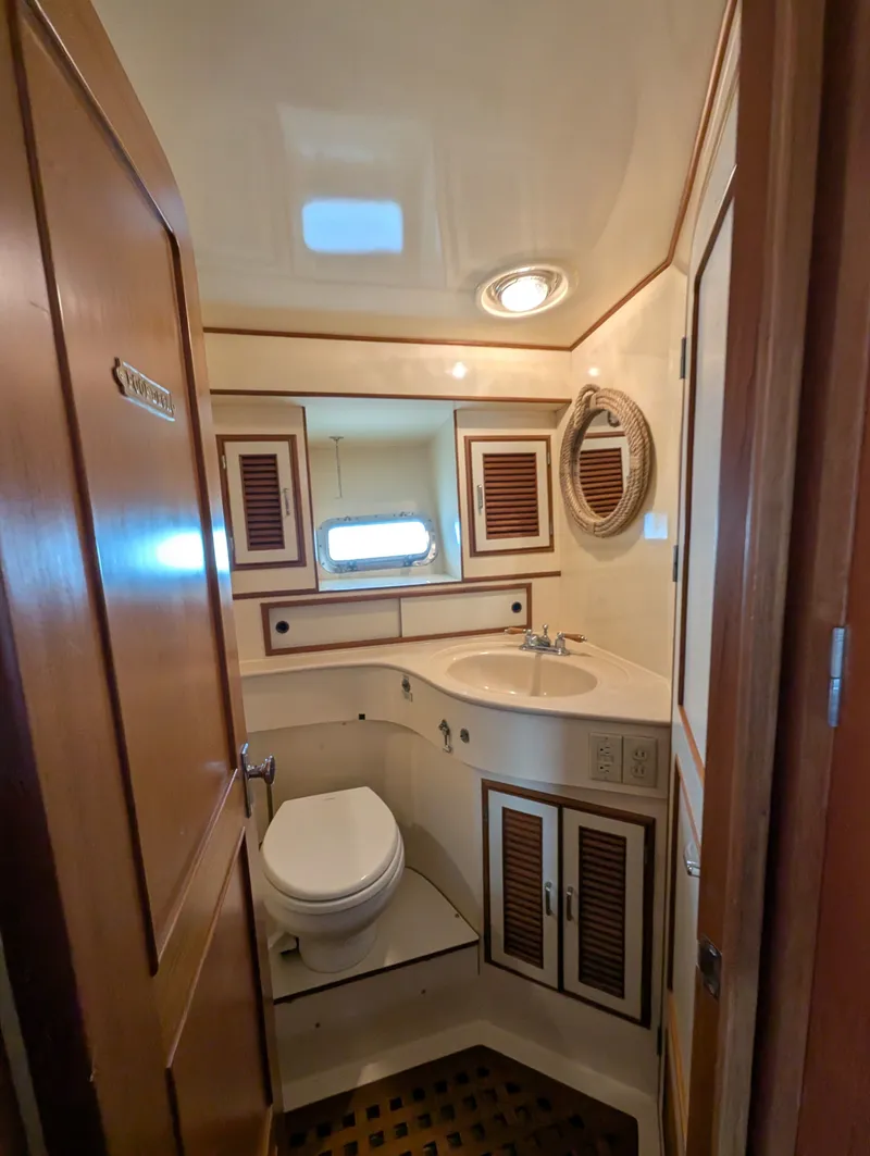 Slide: The Image of 1987 Hi-Star 48 Sundeck yacht bathroom with wooden accents and compact design. - 43