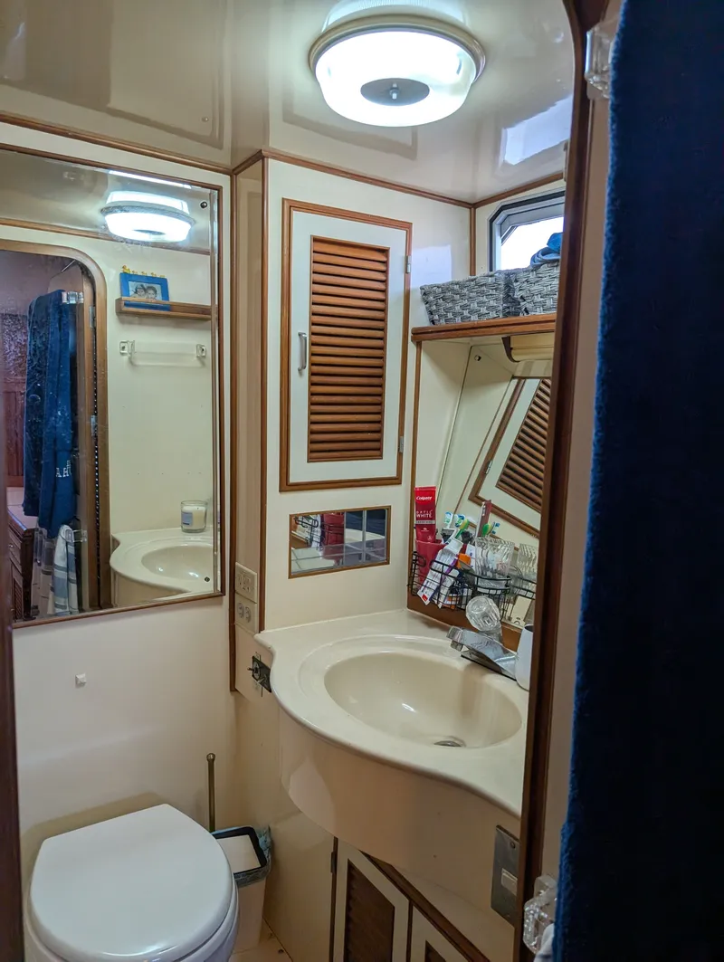 Slide: The Image of 1987 Hi-Star 48 Sundeck bathroom with sink, mirror, and storage cabinets. - 45