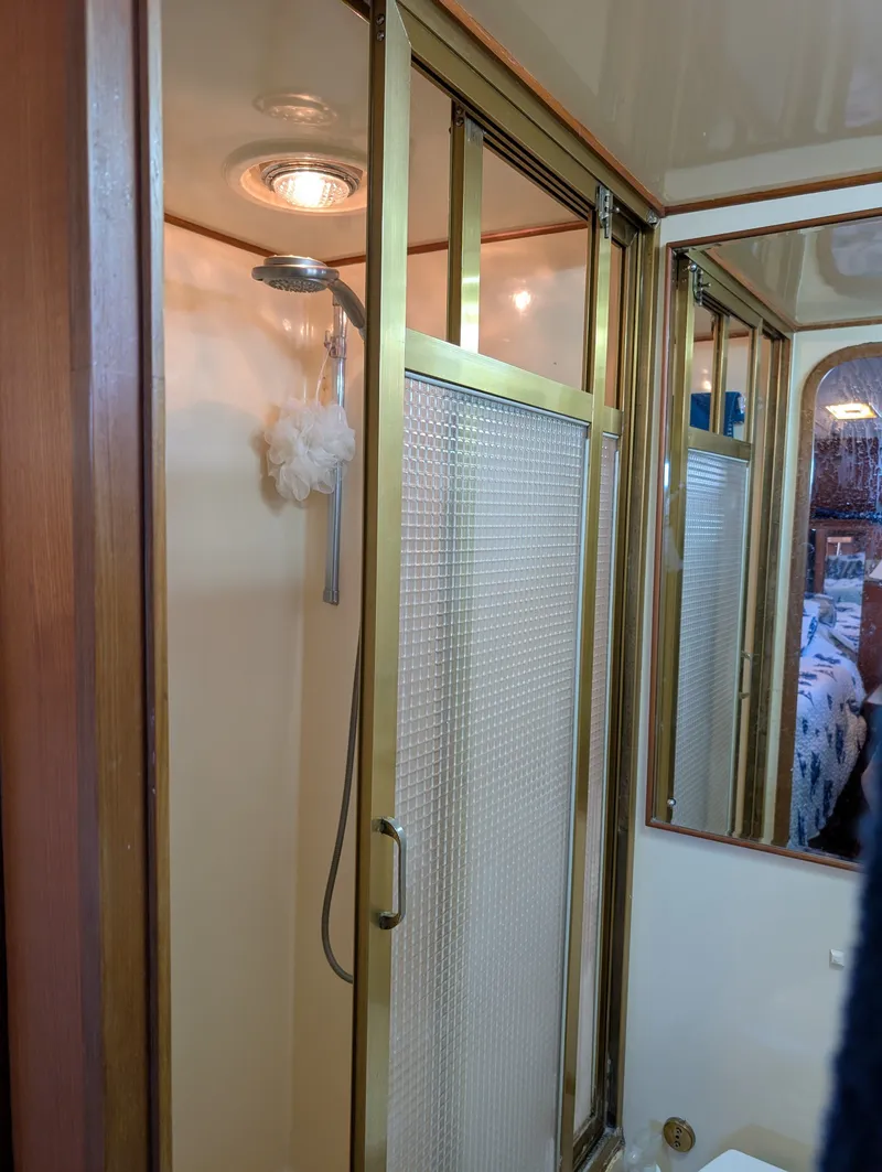 Slide: The Image of Shower area in 1987 Hi-Star 48 Sundeck yacht with gold trim and frosted glass door. - 46