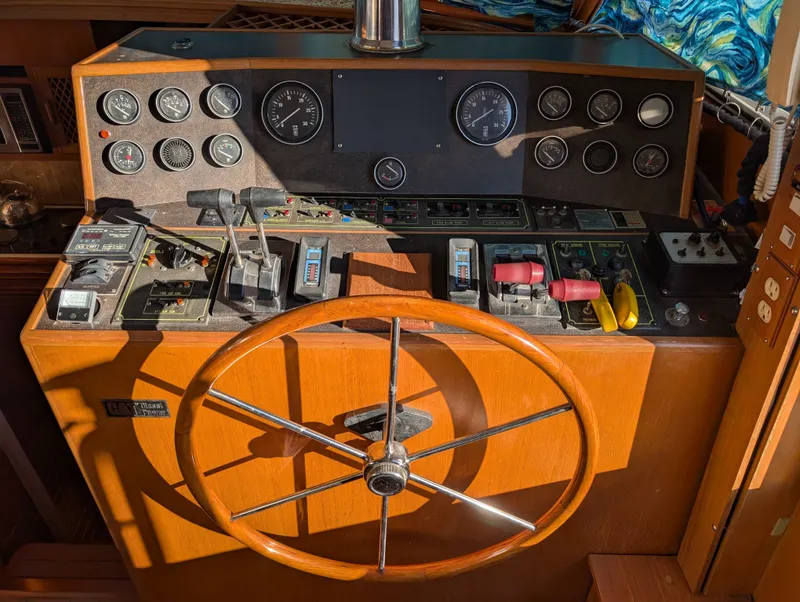 Slide: The Image of 1987 Hi-Star 48 Sundeck helm with gauges, controls, and wooden steering wheel. - 47