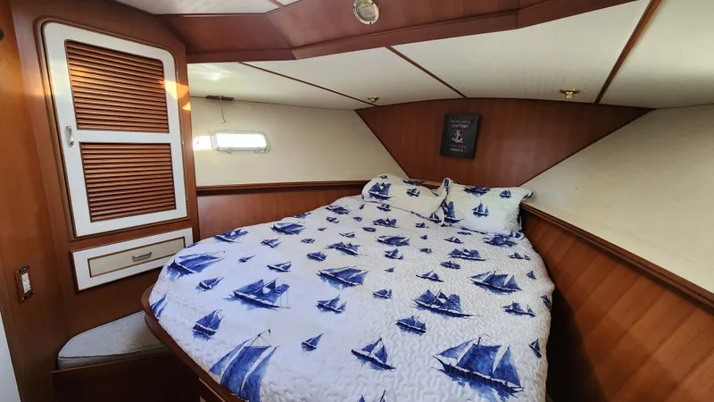 Slide: The Image of Cozy bedroom in 1987 Hi-Star 48 Sundeck yacht with nautical-themed bedding. - 9