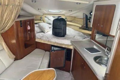 Slide: The Image of Interior of 2003 Regal Commodore 2860 boat with kitchenette and cozy sleeping area. - 10