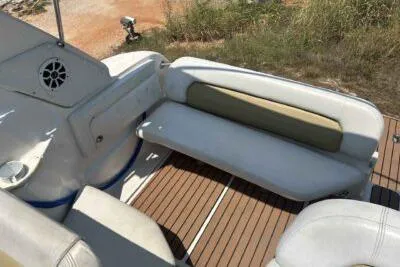 Slide: The Image of 2003 Regal Commodore 2860 boat interior with cushioned seating and wooden deck. - 11