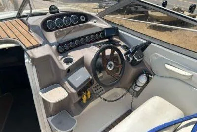 Slide: The Image of 2003 Regal Commodore 2860 boat cockpit with steering wheel and control panel. - 6