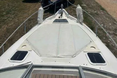 Slide: The Image of 2003 Regal Commodore 2860 boat deck, featuring a spacious sunpad and sleek design. - 7