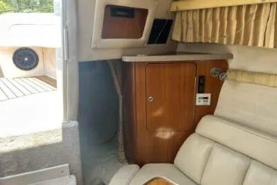 Slide: The Image of 2003 Regal Commodore 2860 cabin interior with seating and wooden cabinetry. - 8