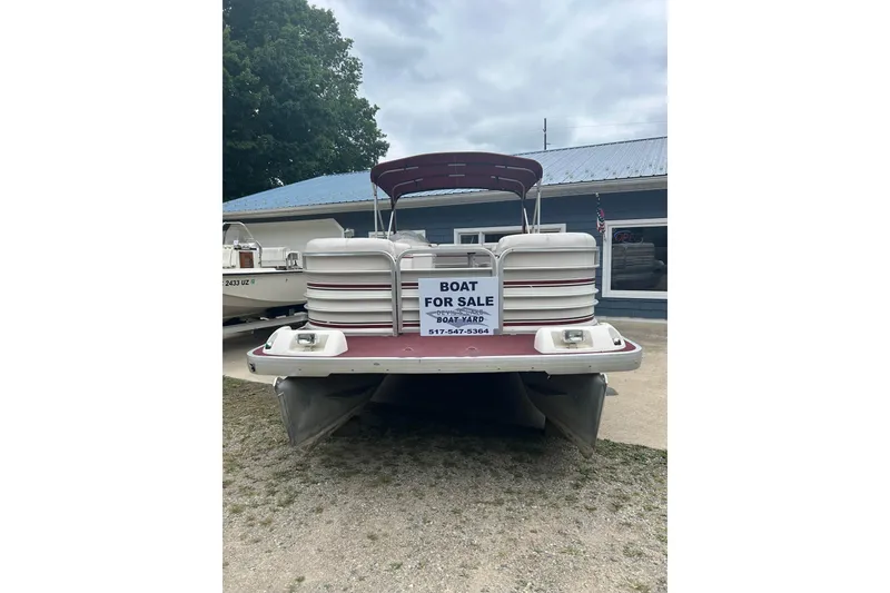 Slide: The Image of 1999 Sanpan 2500 LE pontoon boat for sale, displayed outdoors with a "For Sale" sign. - 2