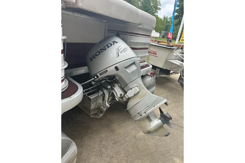 Slide: The Image of 1999 Sanpan 2500 LE pontoon boat with Honda outboard motor. - 6
