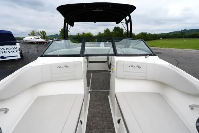 Slide: The Image of 2020 Sea Ray SPX 190 boat interior with white seating and black canopy. - 11