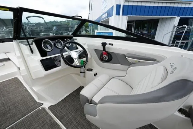 Slide: The Image of 2020 Sea Ray SPX 190 boat interior with steering wheel and dashboard controls. - 13