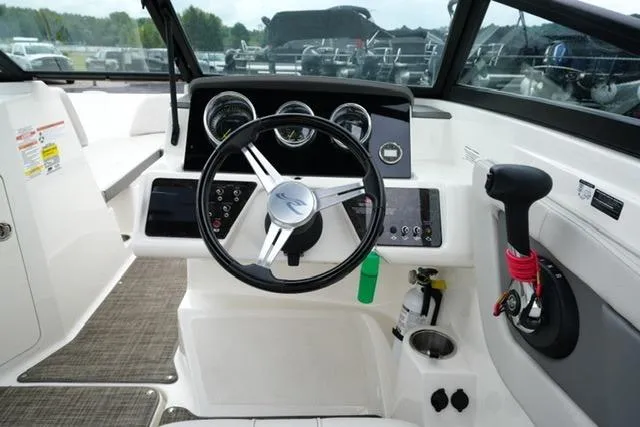 Slide: The Image of 2020 Sea Ray SPX 190 boat dashboard with steering wheel and control panel. - 14