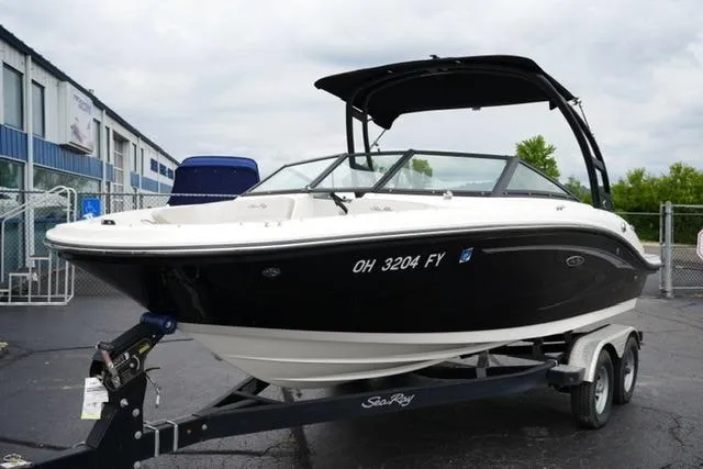 Slide: The Image of 2020 Sea Ray SPX 190 boat on trailer, black and white design, parked outdoors. - 2