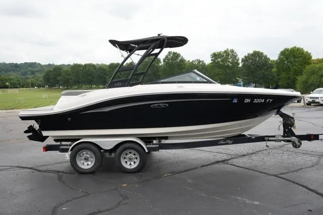Slide: The Image of 2020 Sea Ray SPX 190 boat on trailer, parked outdoors with trees in background. - 4