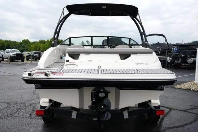 Slide: The Image of 2020 Sea Ray SPX 190 boat, rear view, parked on a lot with overcast sky. - 6