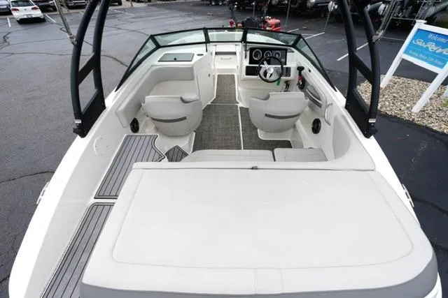 Slide: The Image of 2020 Sea Ray SPX 190 boat interior with seating and steering wheel, docked outdoors. - 8