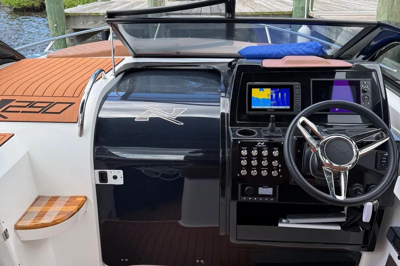 Slide: The Image of 2025 NX Boats NX290 Exclusive dashboard with modern controls and navigation system. - 10