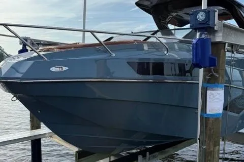 Slide: The Image of 2025 NX Boats NX290 Exclusive docked, showcasing sleek design and modern features. - 3