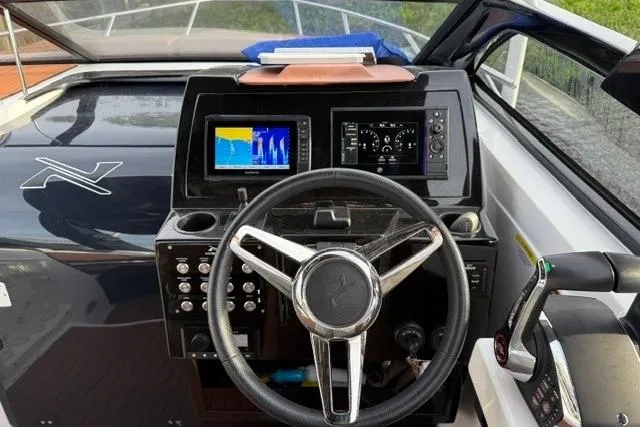 Slide: The Image of Cockpit of 2025 NX Boats NX290 Exclusive with modern navigation displays and controls. - 4