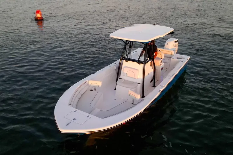 Slide: The Image of 2021 Sea Born LX24 Center Console boat on calm water near buoy. - 2