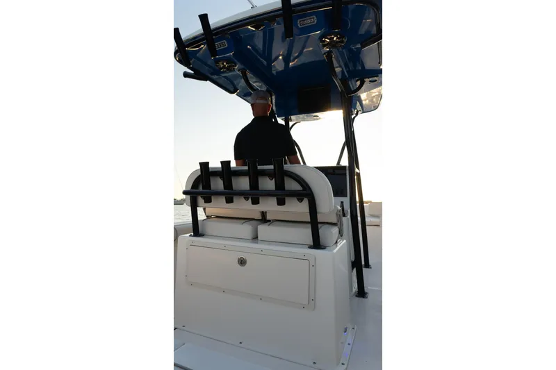 Slide: The Image of 2021 Sea Born LX24 Center Console boat with a person at the helm, viewed from behind. - 21